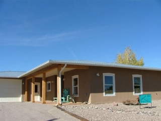 territorial style home with metal roof