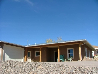 Territorial style house with metal roof