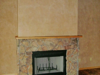 gas fireplace with rock work and Venetian plaster